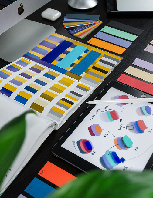 Open notebook with handwritten strategy notes and an orange leather wallet on a desk