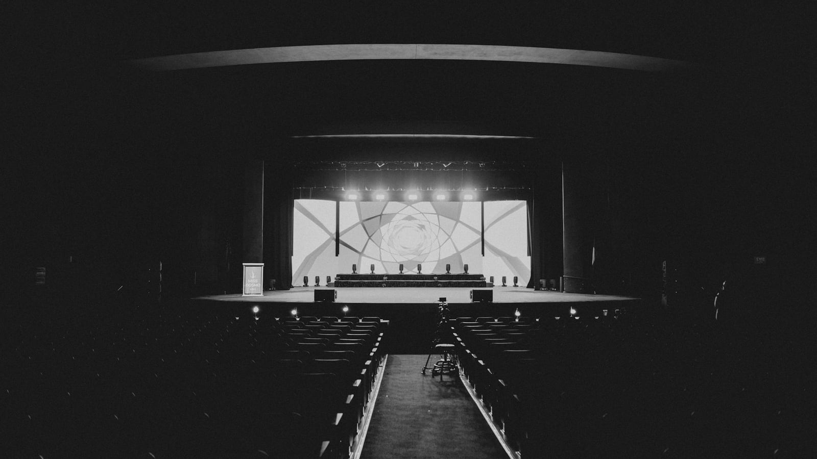 A lit stage inside a dark theater